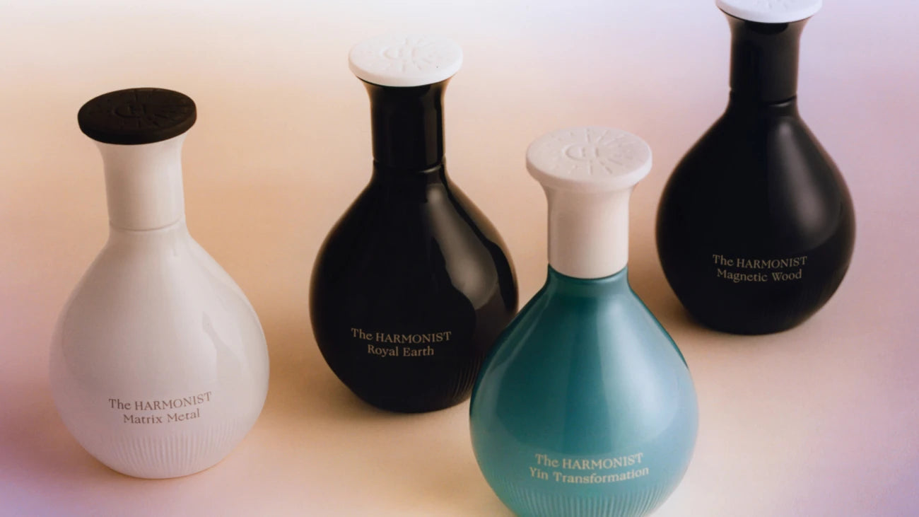 The Harmonist perfume bottles in various colors, including Matrix Metal, Royal Earth, Yin Transformation, and Magnetic Wood.